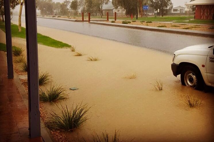 Rain floods a street in Birdsville after an overnight downpour.