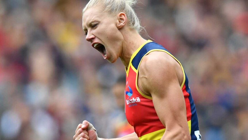 Erin Phillips clenches her fist and screams in delight