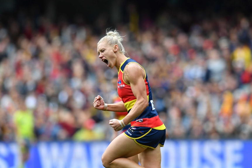 Erin Phillips clenches her fist and screams in delight