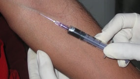 Syringe taking blood from a patient