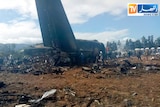 Firefighters and civil security officers work at the scene of a fatal military plane crash in Algeria.