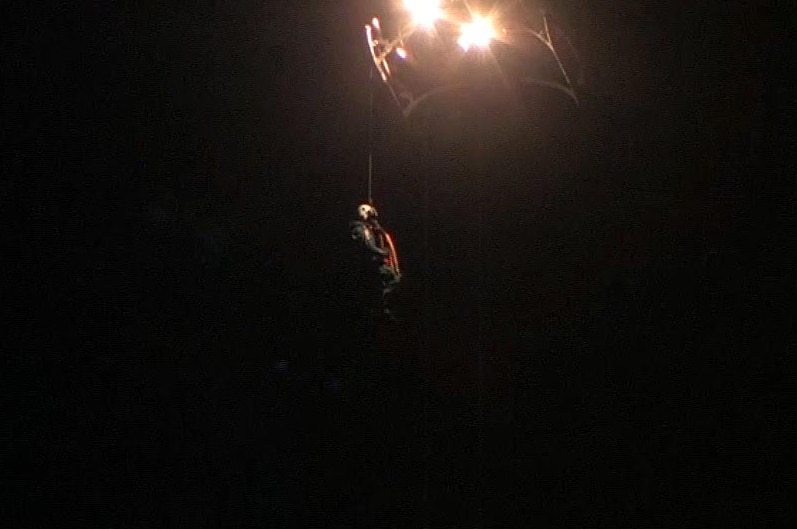 Rescue worker on a winch from a helicopter.
