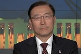 A still of Lee Baeksoon answering interview questions on the ABC.