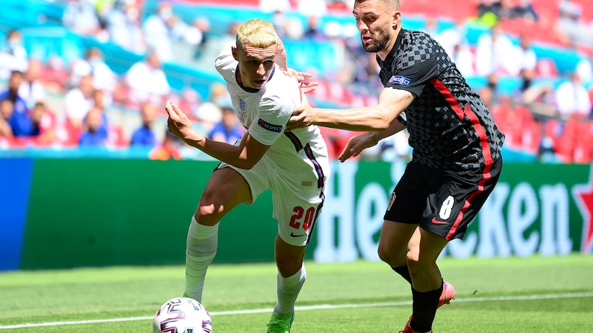 Phil Foden runs past a Croatia player