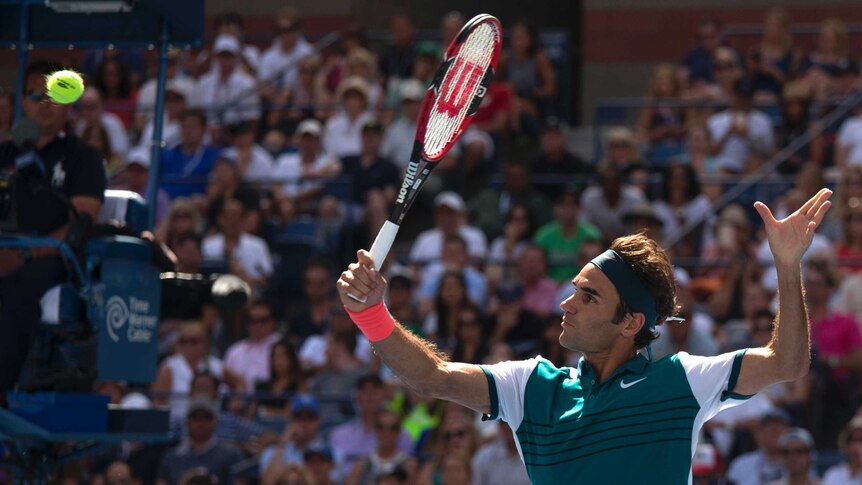 Roger Federer volleys at the US Open