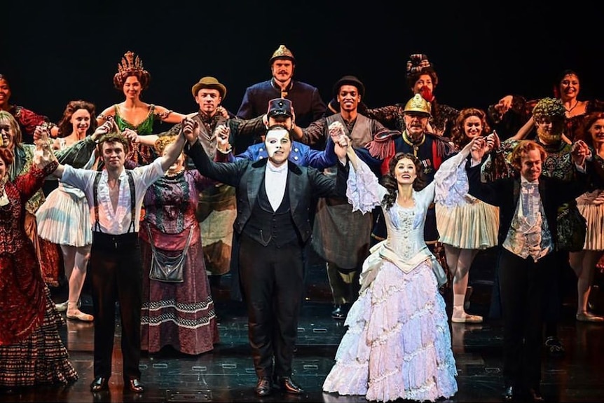 The cast of Phantom of the Opera bow at their curtain call.