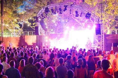 An audience watches a show on the Darwin Festival Lighthouse stage at Civic Park.