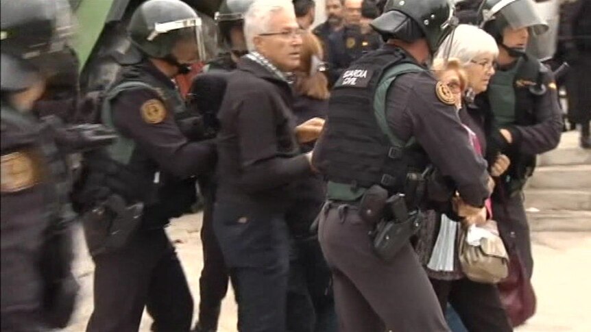 Riot police clash with referendum voters in Catalonia