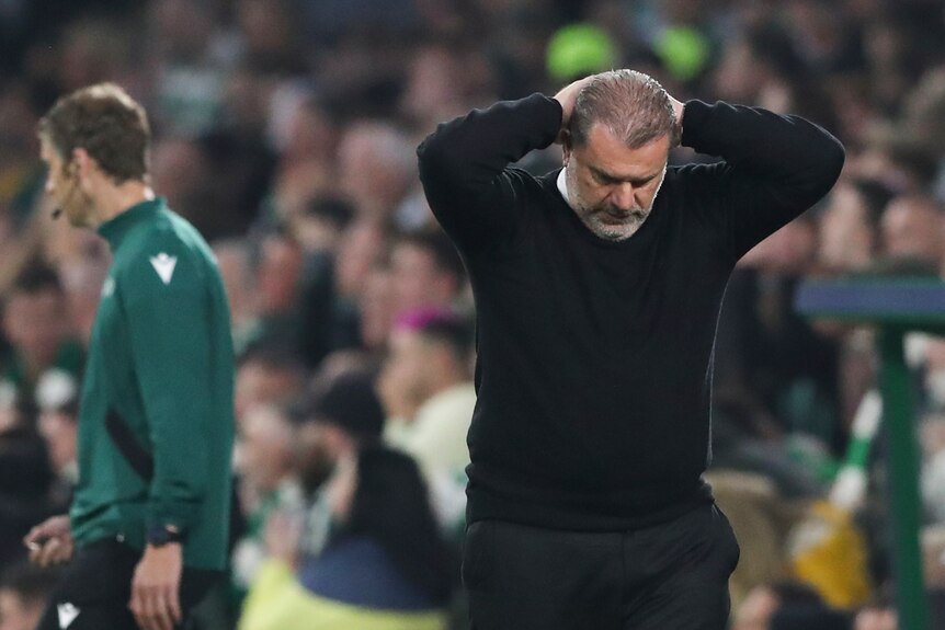 Celtic coach Ange Postecoglou puts his hands behind his head in frustration during a Champions League match in Glasgow.