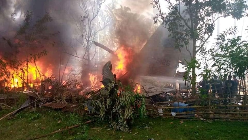 Wreckage in flames of Philippine air force C-130 aircraft that crashed in Sulu province.