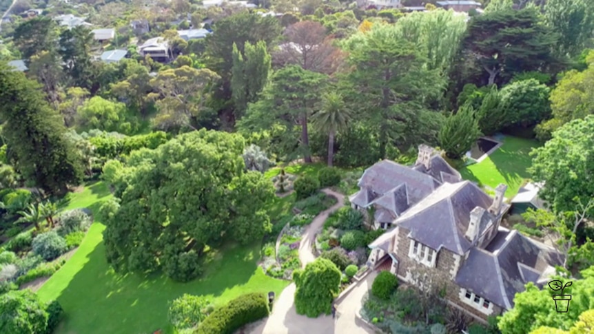 Ariel photo of large property surrounded by expansive gardens