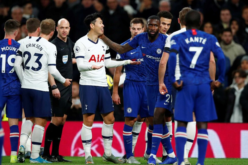 Chelsea's Antonio Rudiger puts his hand on Tottenham's Son Heung-min's cheek.