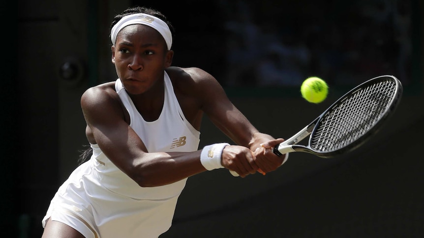 Cori 'Coco' Gauff returns a shot with a backhand on the Wimbledon courts