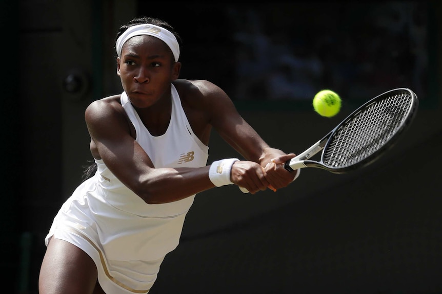 Cori 'Coco' Gauff returns a shot with a backhand on the Wimbledon courts