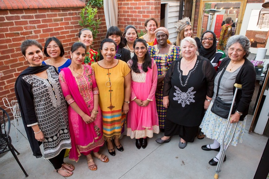 A group of women stand together.