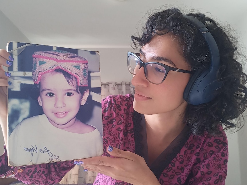 Mariam Mohammed is holding a photo of herself as a baby.