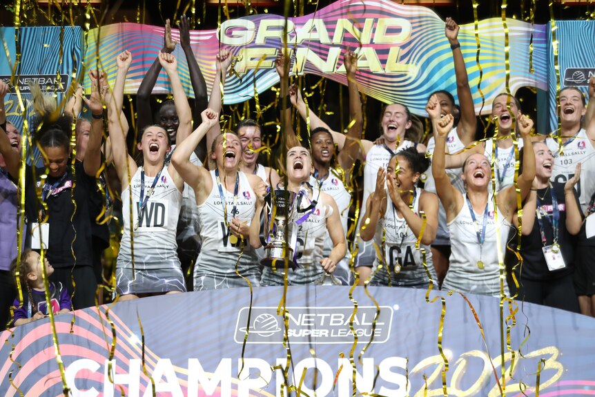 Netballers hold the trophy high