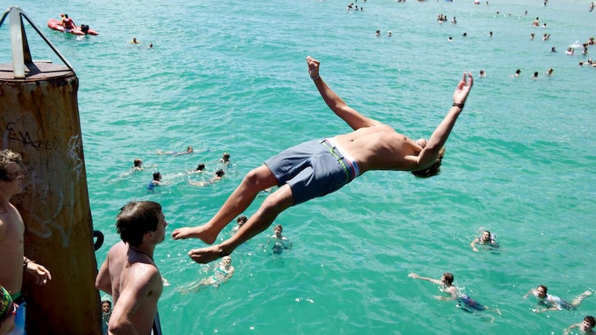 Teenagers jumping from Glenelg jetty, South Australia