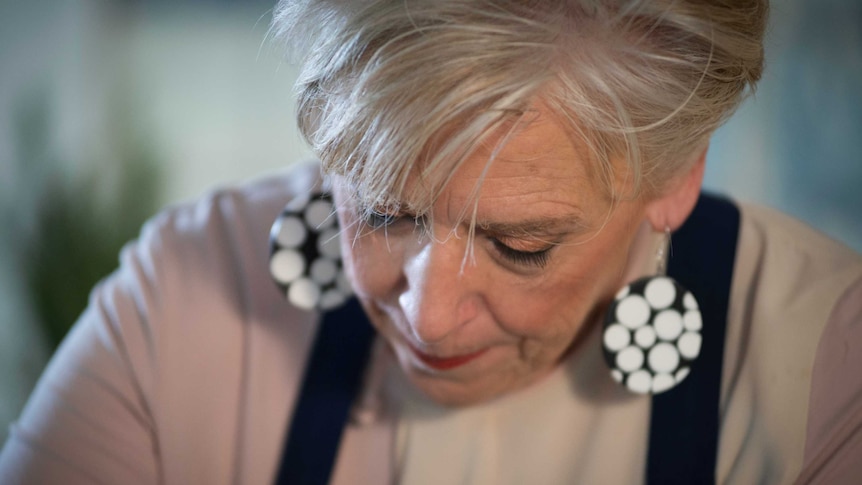 Maggie Beer looks down while cooking
