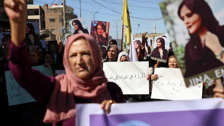 Women carry banners during a protest