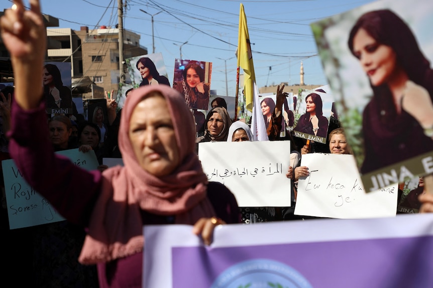 Women carry banners during a protest