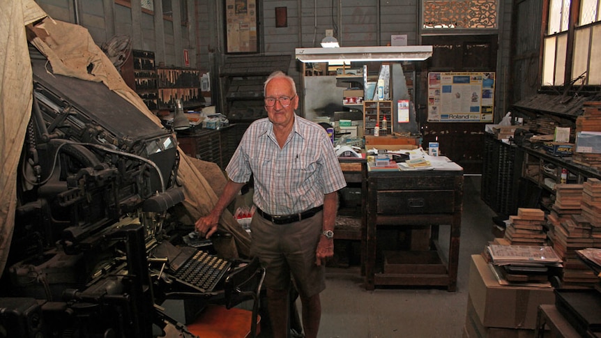 Stewart next to the old linotype machine