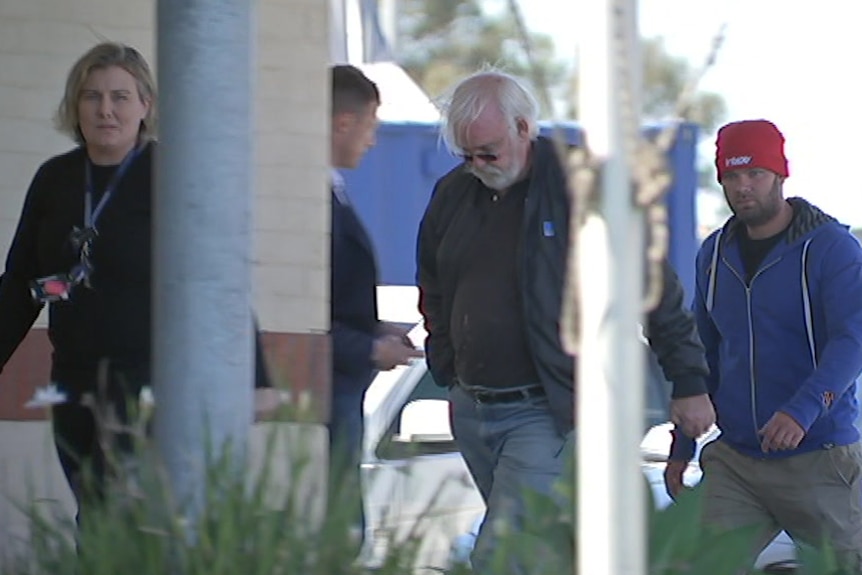 Three people entering a government building