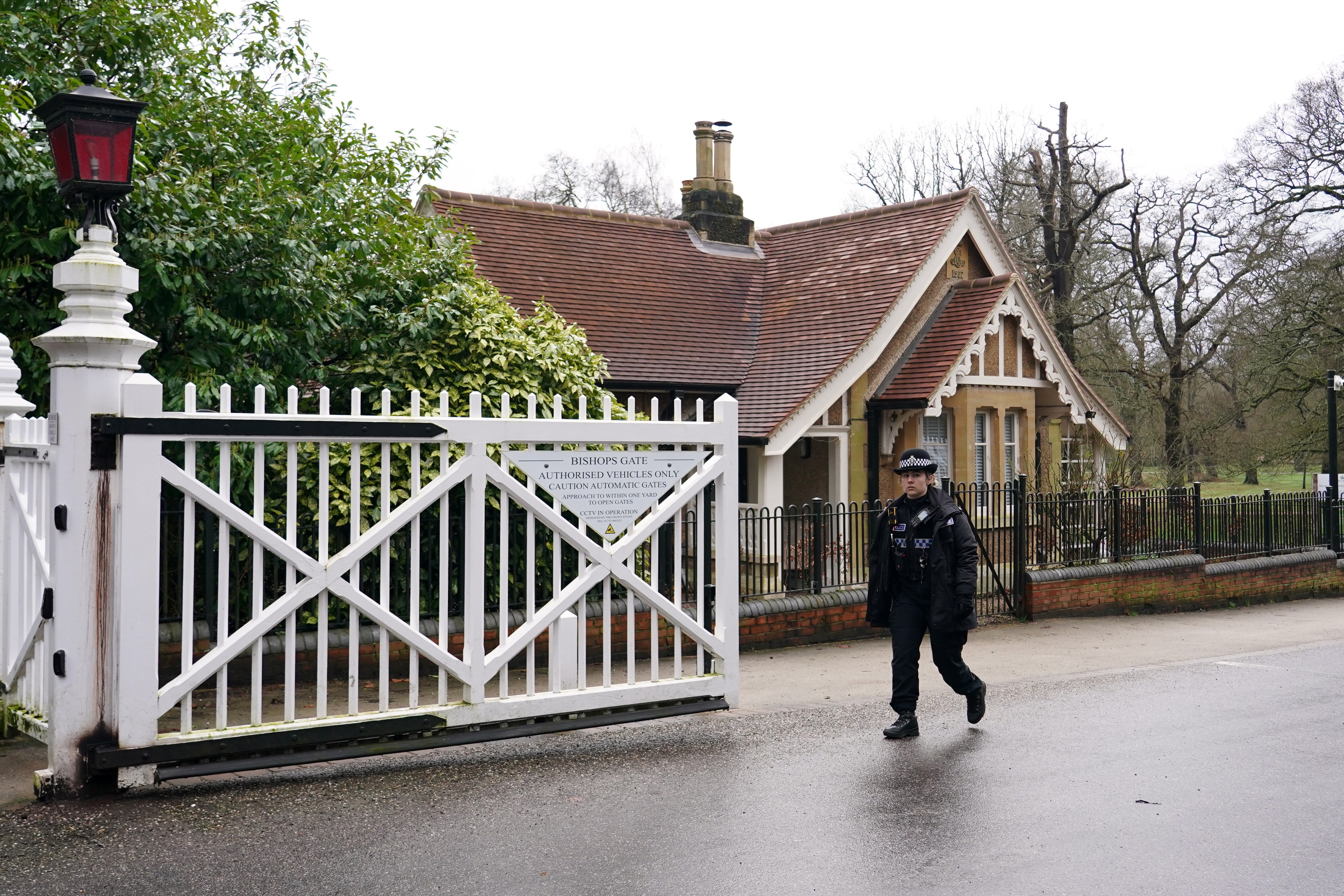 A police officer passes the gate of the Royal Lodge in Windsor.
