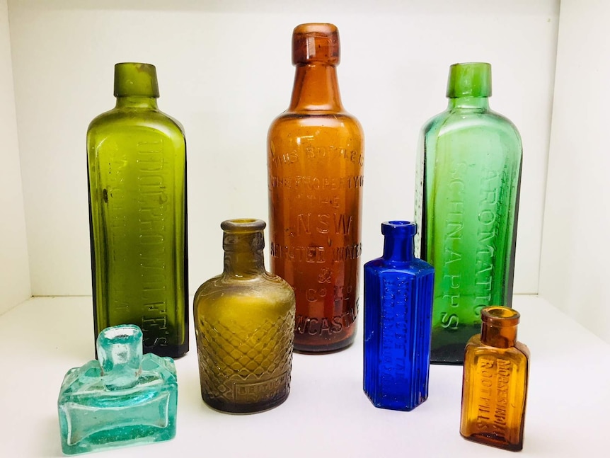 A collection of antique coloured bottles.