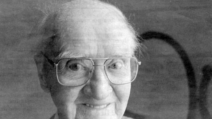 Black and white photo of WWI veteran John 'Jack' Ross holding medal