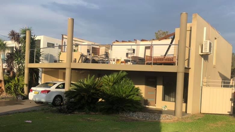 Two storey house with its roof ripped off