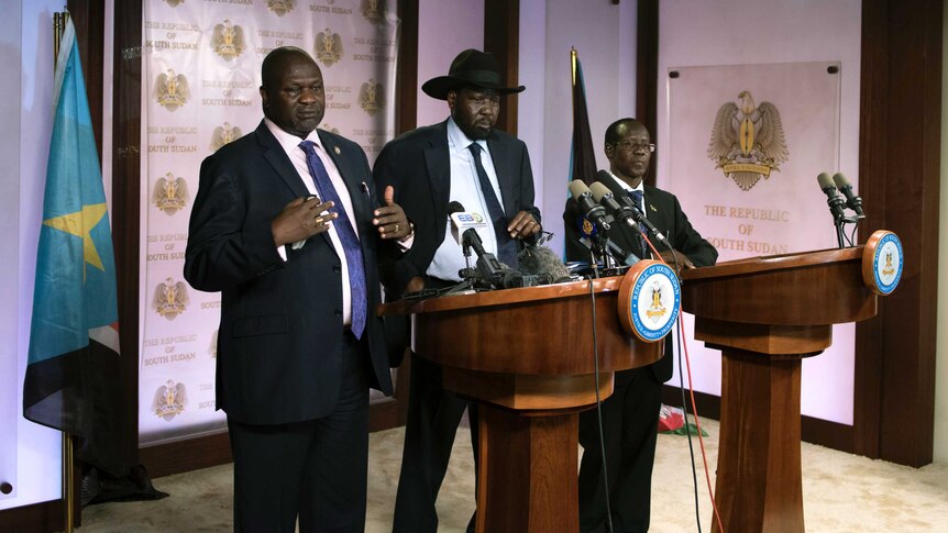 First Vice President Riek Machar (L) delivers a speech next to South Sudan President Salva Kiir (C) prior to the incident.