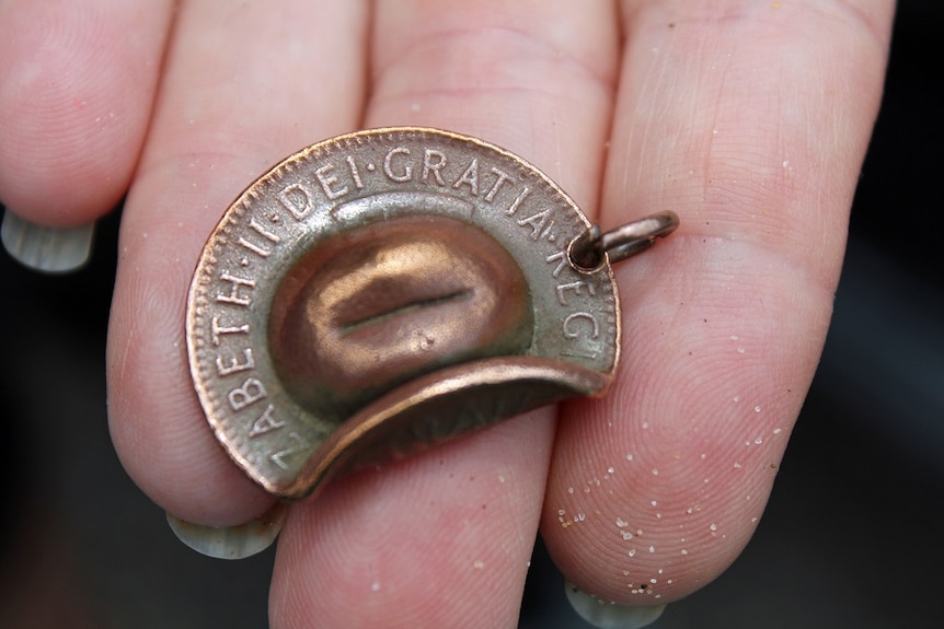 Small metal slouch hat with writing engraved.