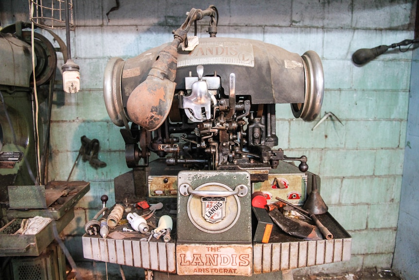 An ancient machine used to stitch the soles of shoes resides in the workshop out the back of the shop