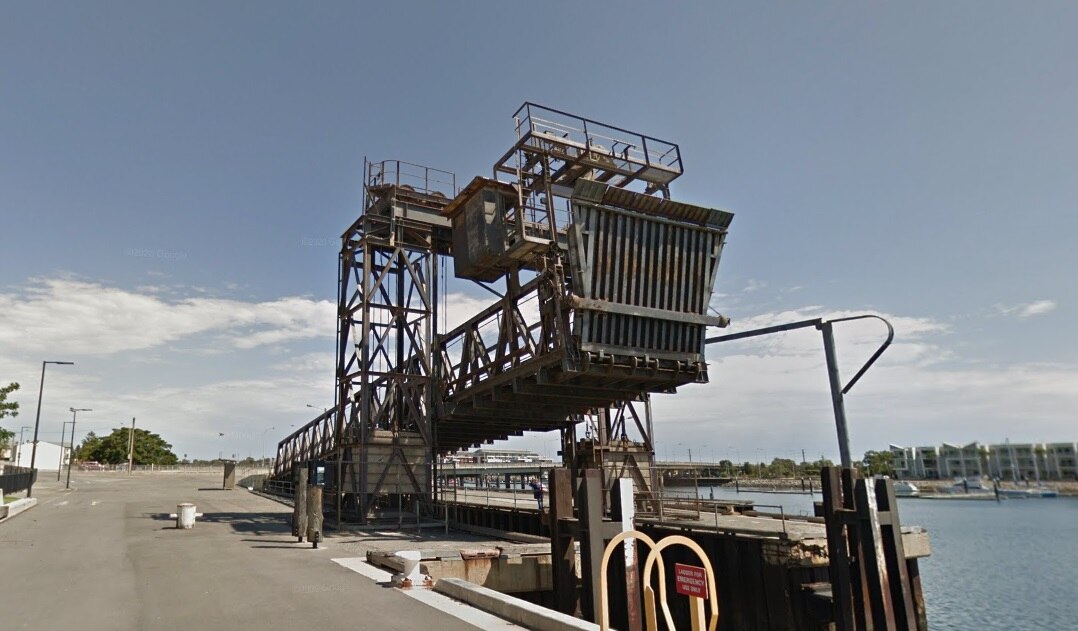 A large metal loading ramp next to a river