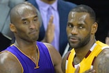 Kobe Bryant of the LA Lakers pats LeBron James of the Cleveland Cavaliers on the chest during an NBA game.