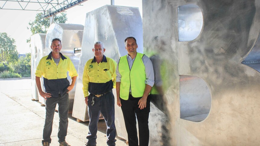 Fabricators Royce and Chris with Councillor Matthew Burke in front of the recently built Brisbane sign letters.
