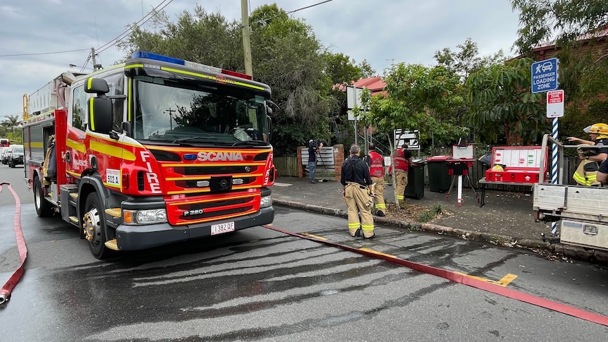 an image of a fire fighting truck on a street in brisbane with emergency service crews 