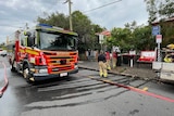 an image of a fire fighting truck on a street in brisbane with emergency service crews 