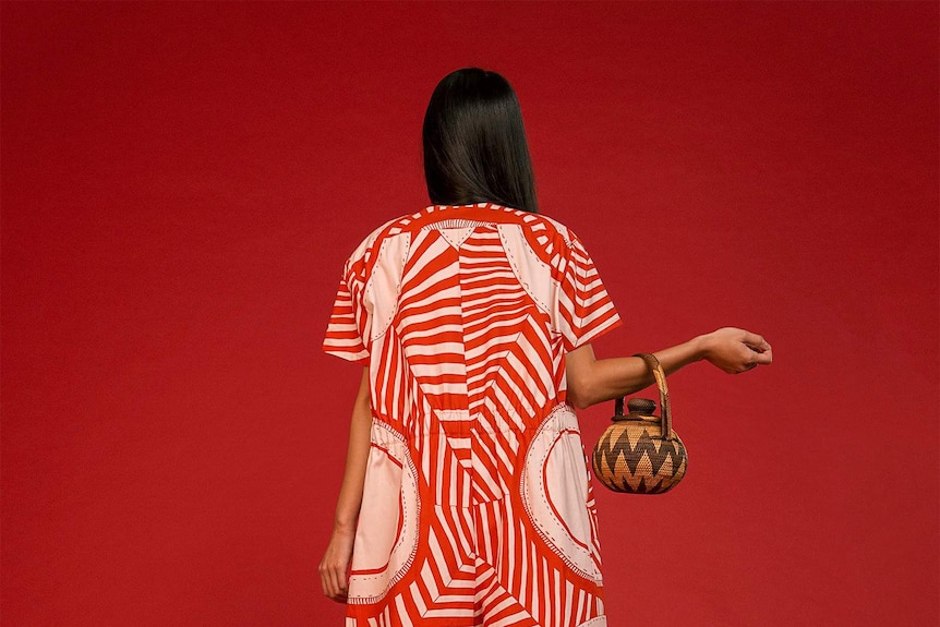 Model wearing red and white stripe jumpsuit from Lisa Waup and Verner collaboration for a story about cultural appropriation.