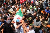 Palestinians attend the funeral of the wife of Hamas military leader Mohammed Deif