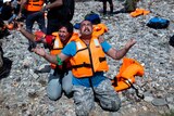 Refugees from Syria pray after arriving on the shores of the Greek island of Lesbos aboard an inflatable dinghy across the Aegean Sea from from Turkey