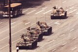 Man stands in front of Chinese Tank