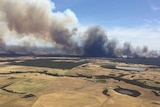 Smoke billowing over farmland