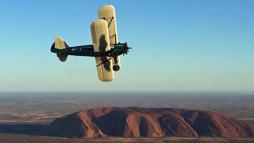 1942 Boeing Stearman Spirit of Artemis flies over Uluru in Australia