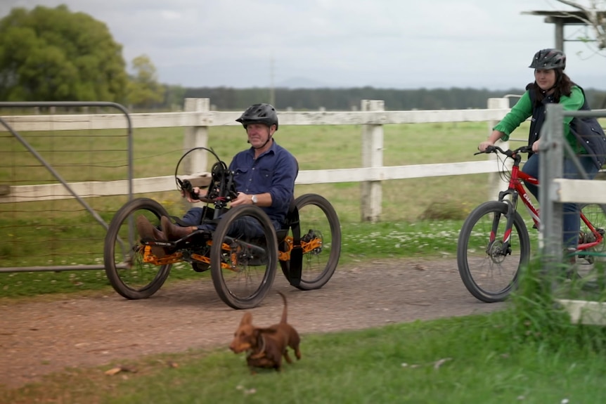 Photo of a man and a woman riding a bike.