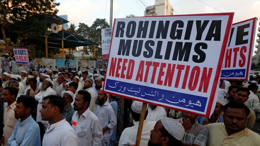 Human rights activists hold a sign reading "Rohingya Muslims need attention".