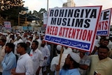 Human rights activists hold a sign reading "Rohingya Muslims need attention".