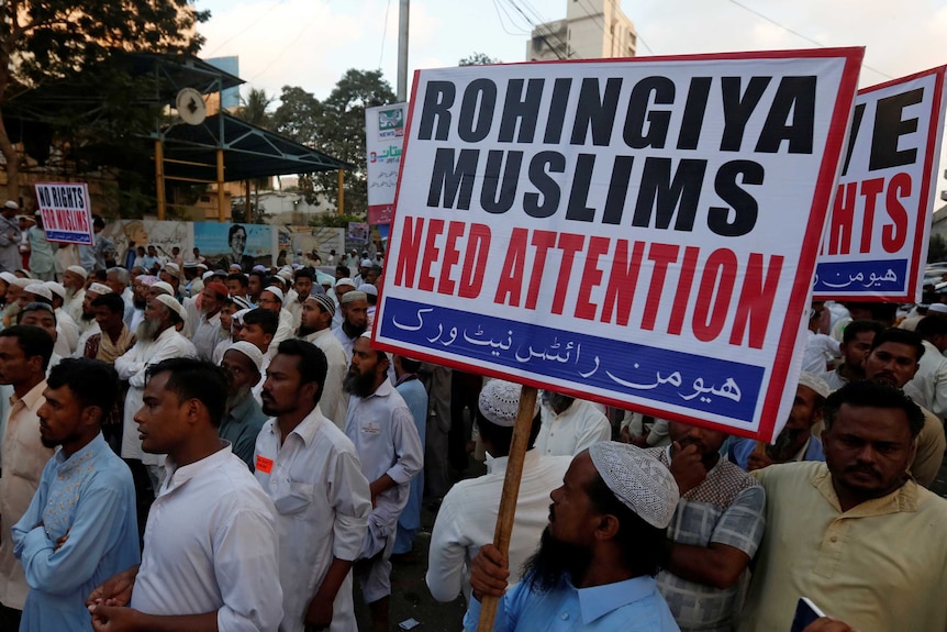 Human rights activists hold a sign reading "Rohingya Muslims need attention".