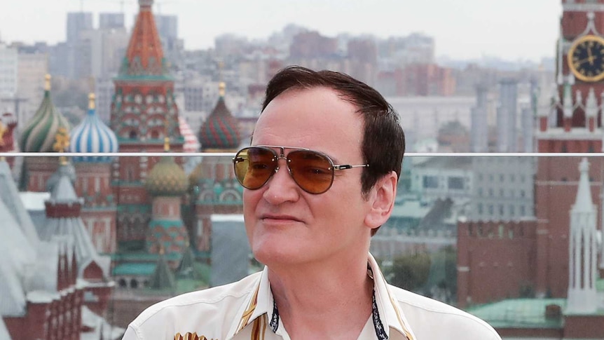 A man poses in front of Red Square